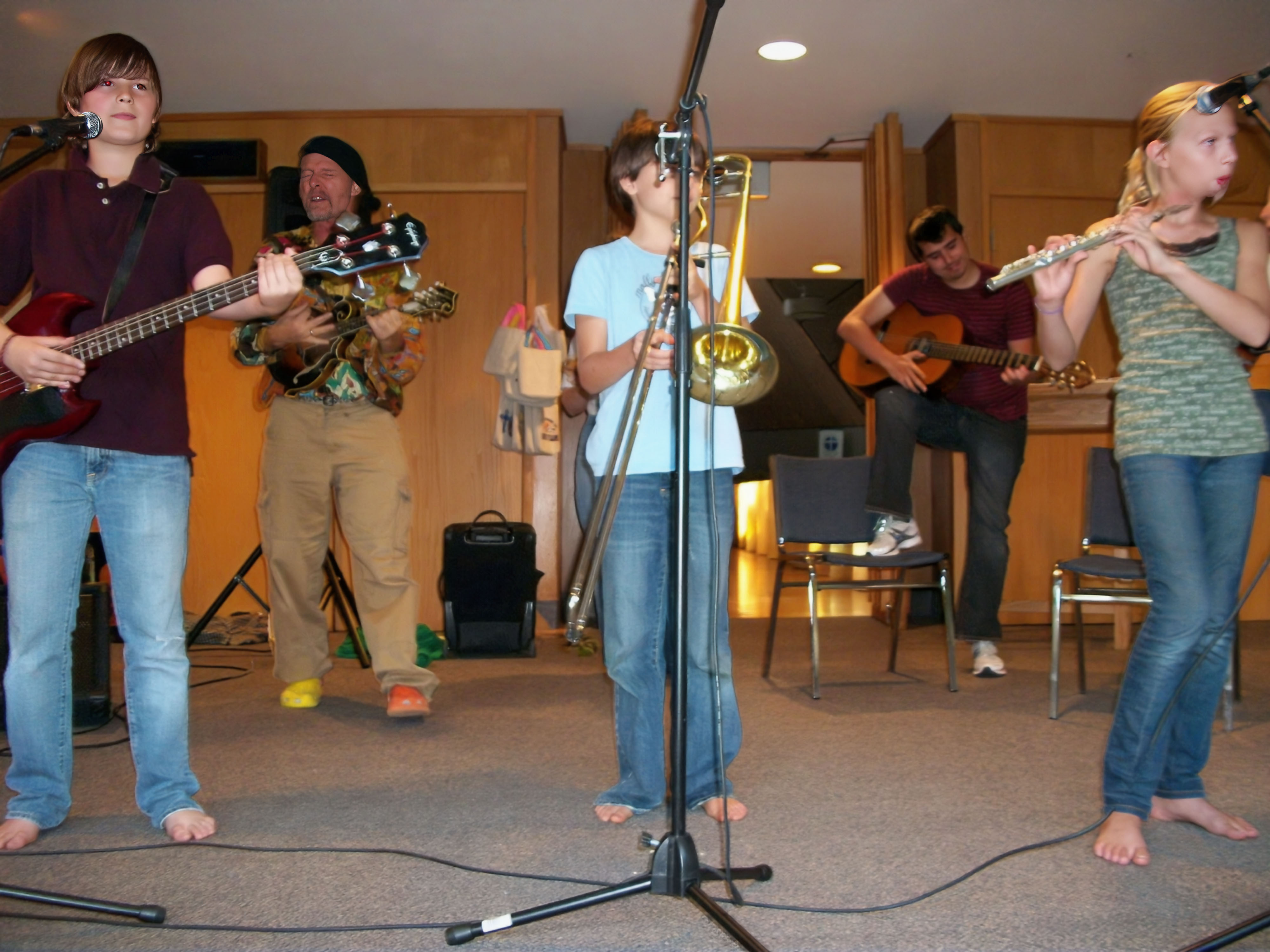 Full ensemble of kids with horns, strings, keys, and drums