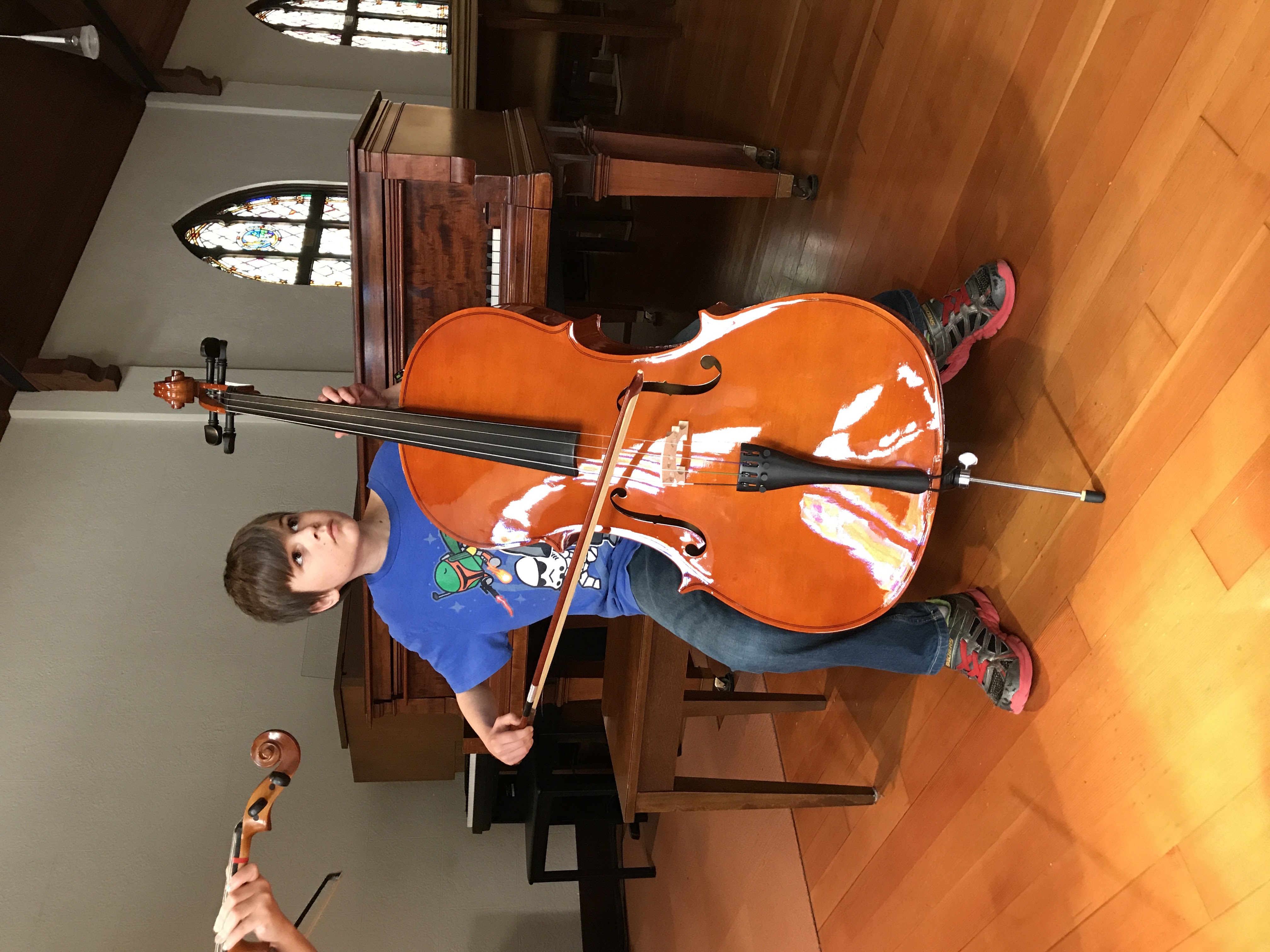 Child expressing emotion on cello